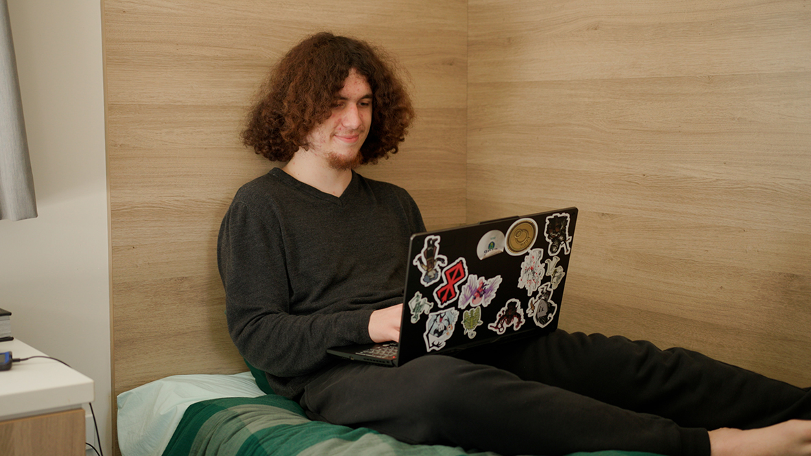 A Merredin Residential College boarder reading on his bed.