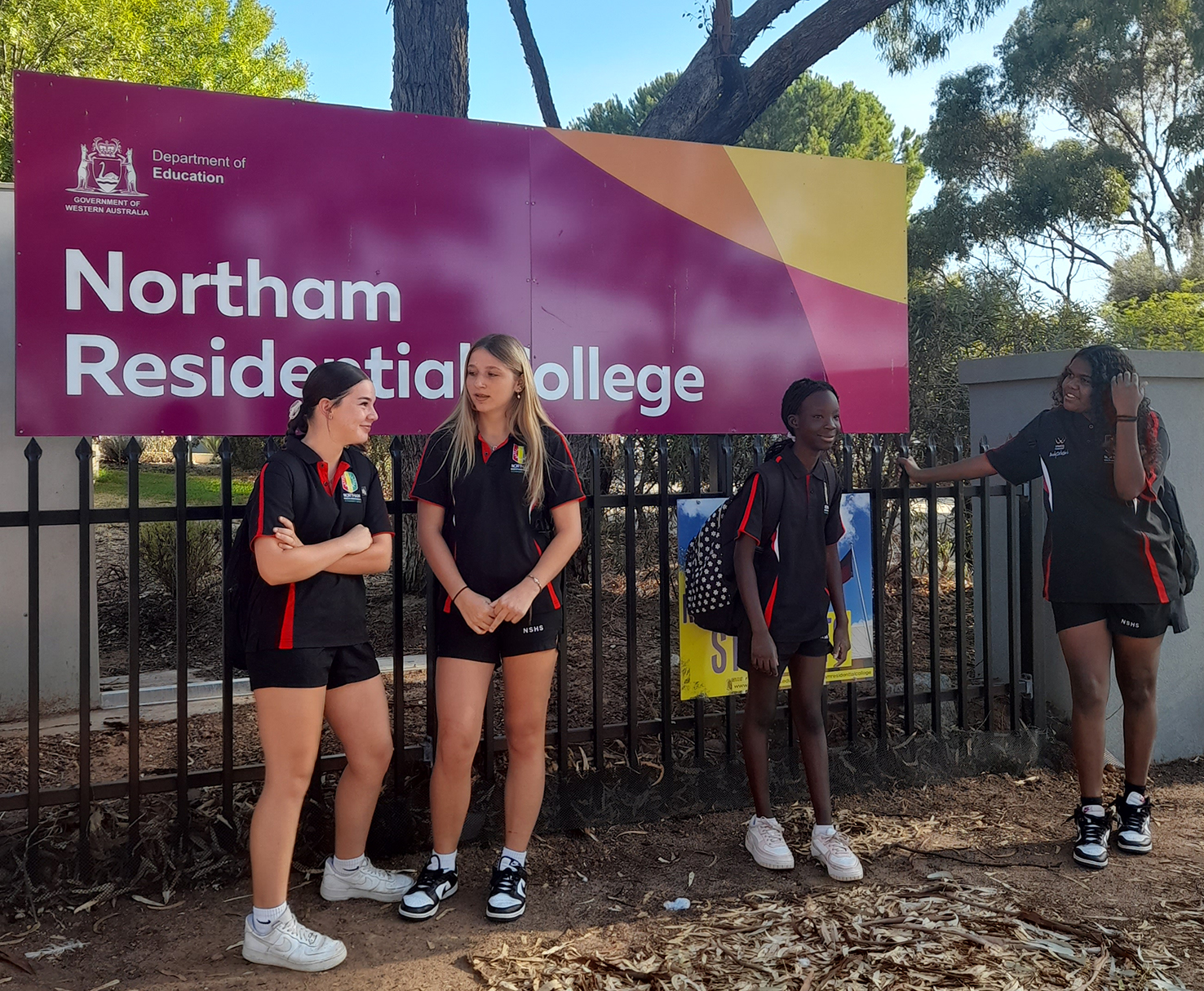 Northam Residential College boarders standing in front of the college sign