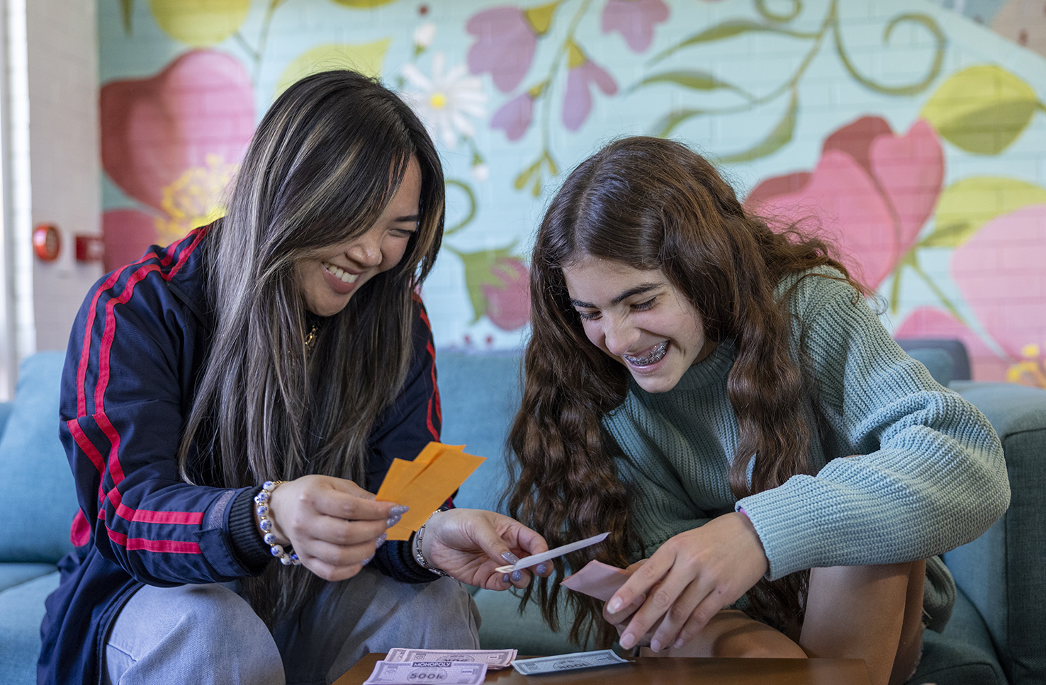 Narrogin Residential College boarding supervisor playing board games with smiling boarders.
