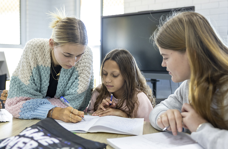 A boarding supervisor from Narrogin Residential College helping students with homework.