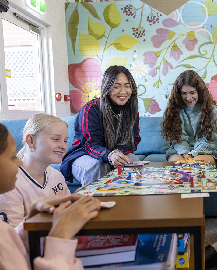 Narrogin Residential College boarders playing monopoly in the girls dorm common room.