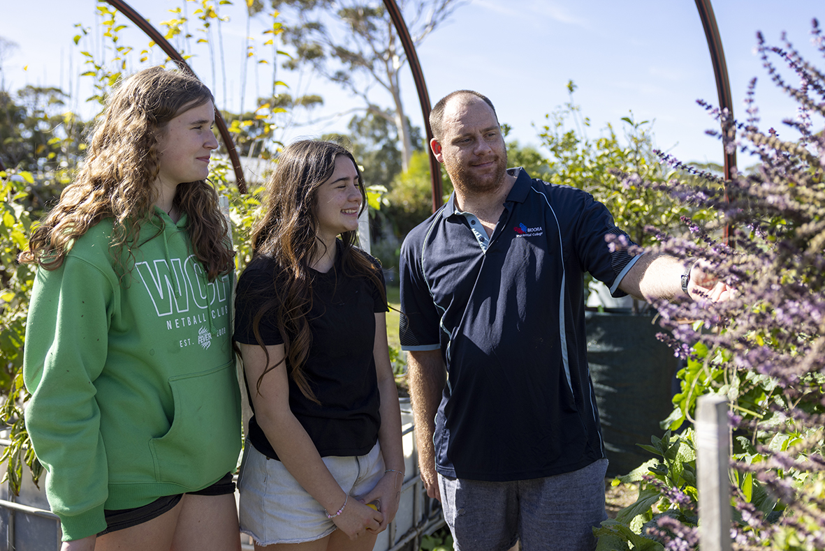 Boarding Supervisor from Moora Residential College pointing out lavender in the garden with students