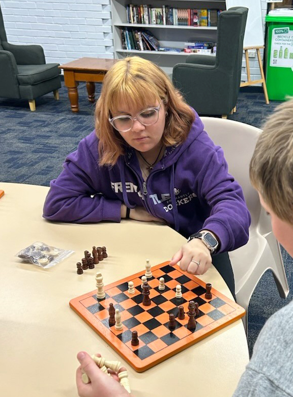 Merredin Residential College boarders playing checkers in the common room.