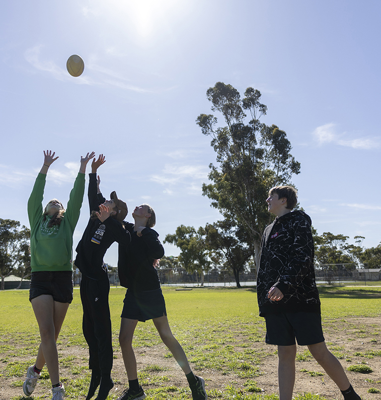 Moora Residential College boarders playing football on the college oval.