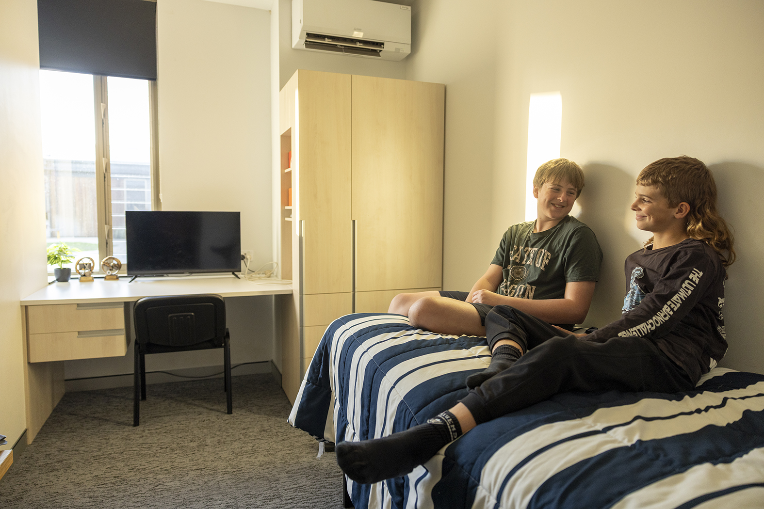 Moora Residential College boarders sitting in a bedroom