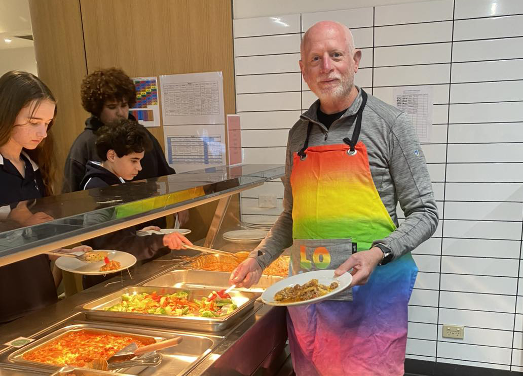 Boarding supervisor stepping in to help serve dinner.