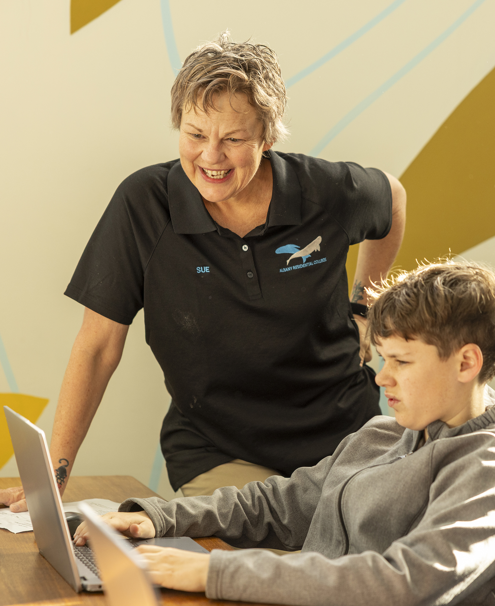Albany Residential College boarding supervisor helping a student with homework