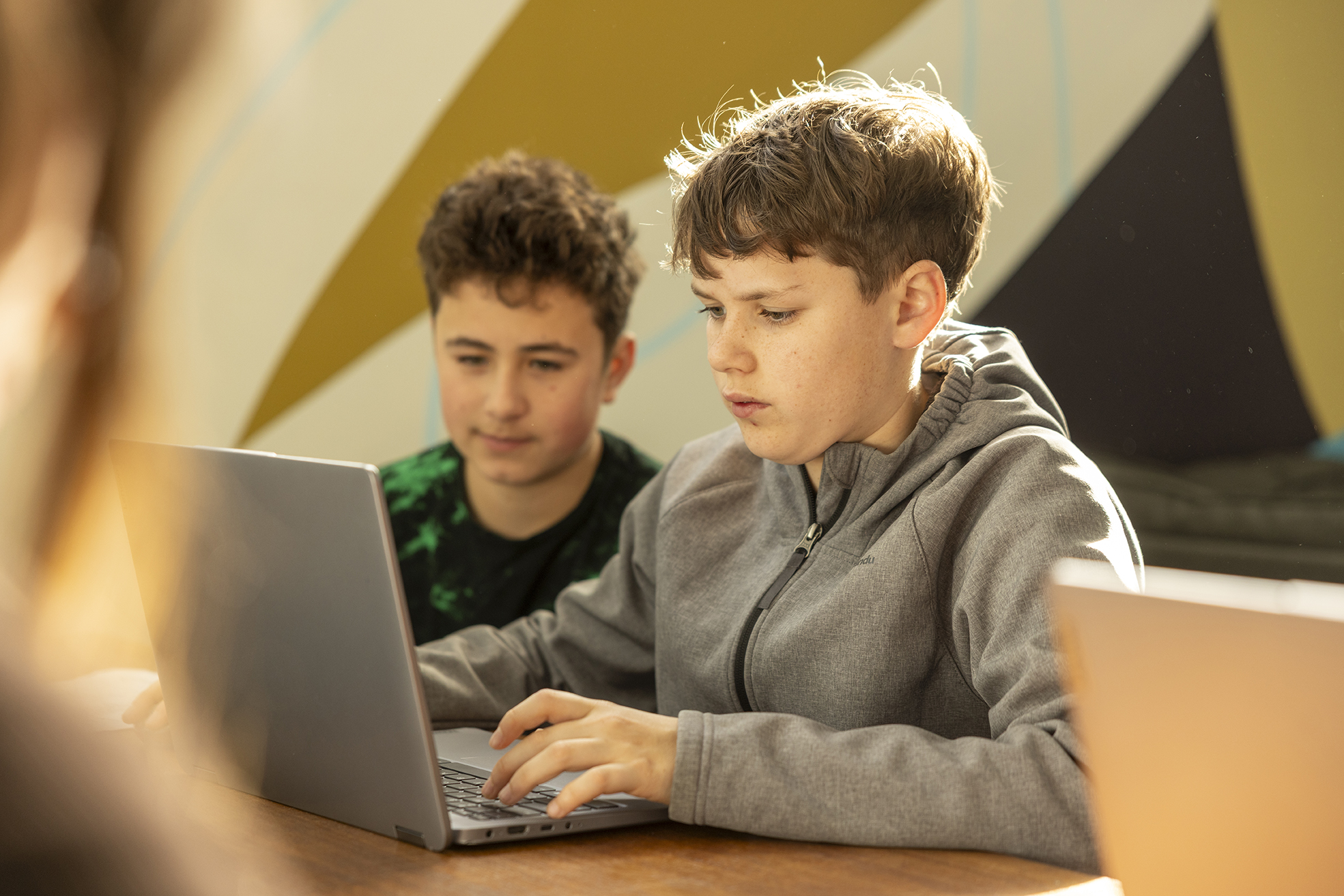Boys working on a laptop at Albany Residential College