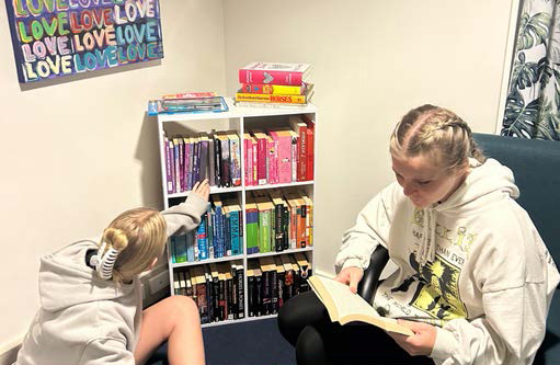 Girls reading in one of the common spaces at Albany Residential College