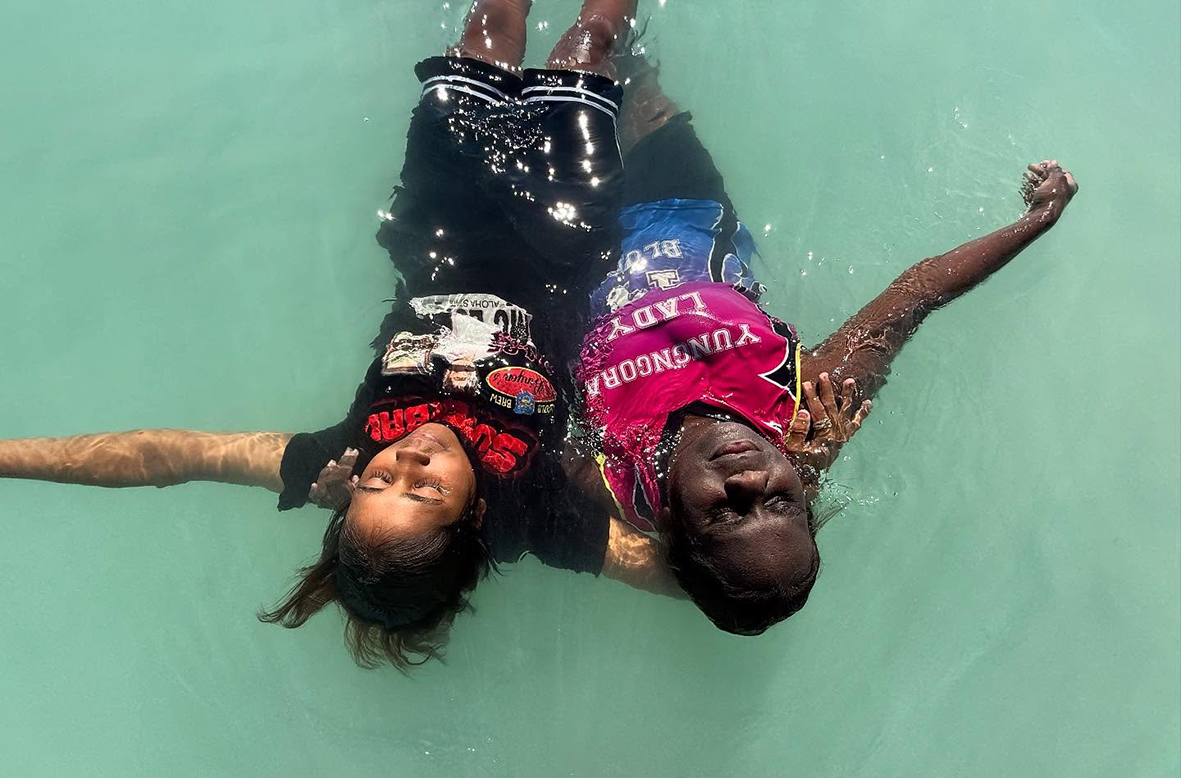 Relaxed Broome Residential College boarders floating in the ocean.