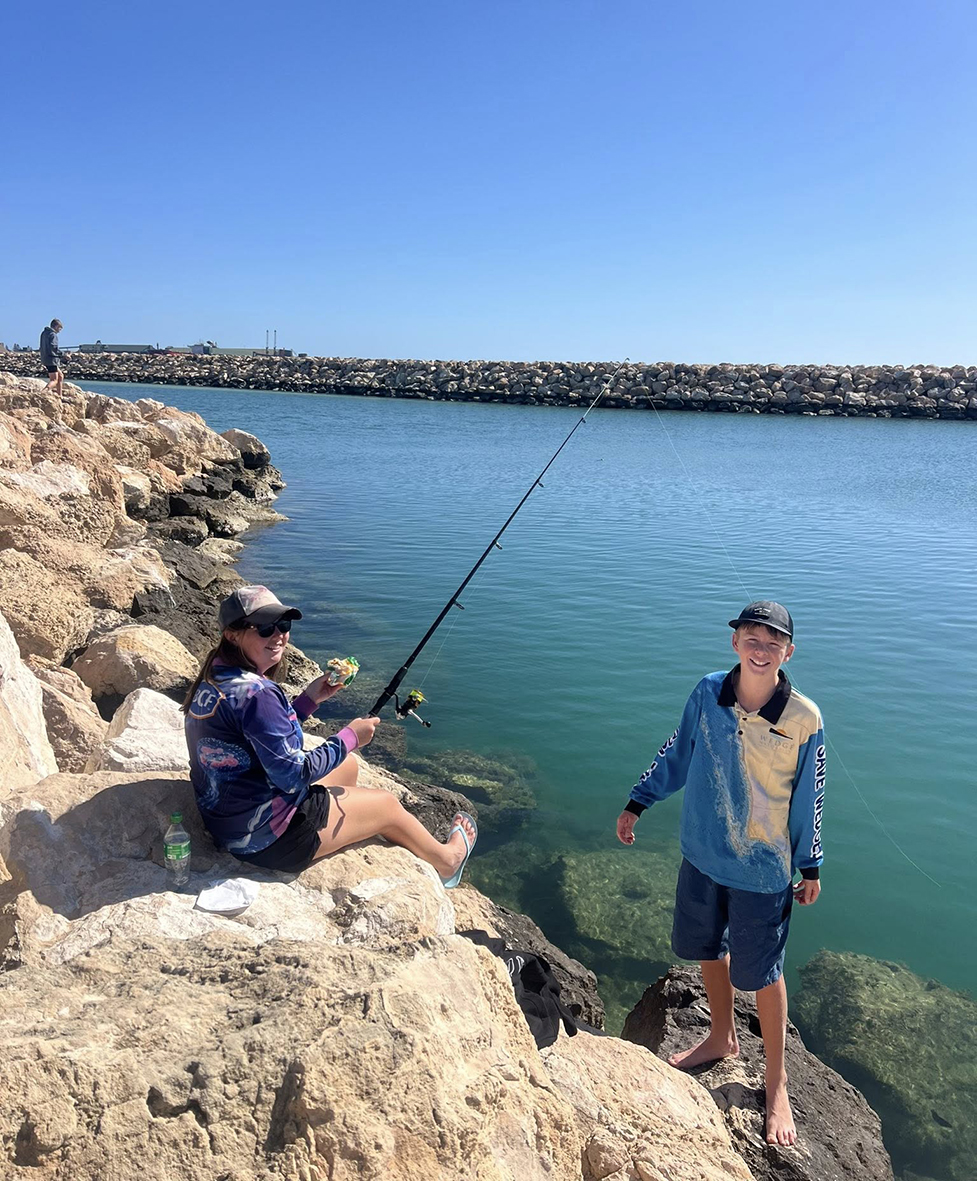 Boarders from Geraldton Residential College fishing off the jetty on a bright sunny weekend afternoon.