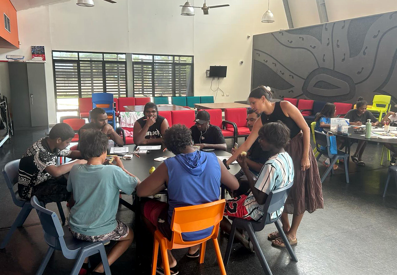 Boarders working on t-shirt design in the dining room.