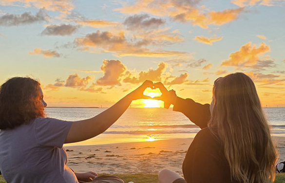 Boarders from Geraldton Residential College sitting in the sunset.
