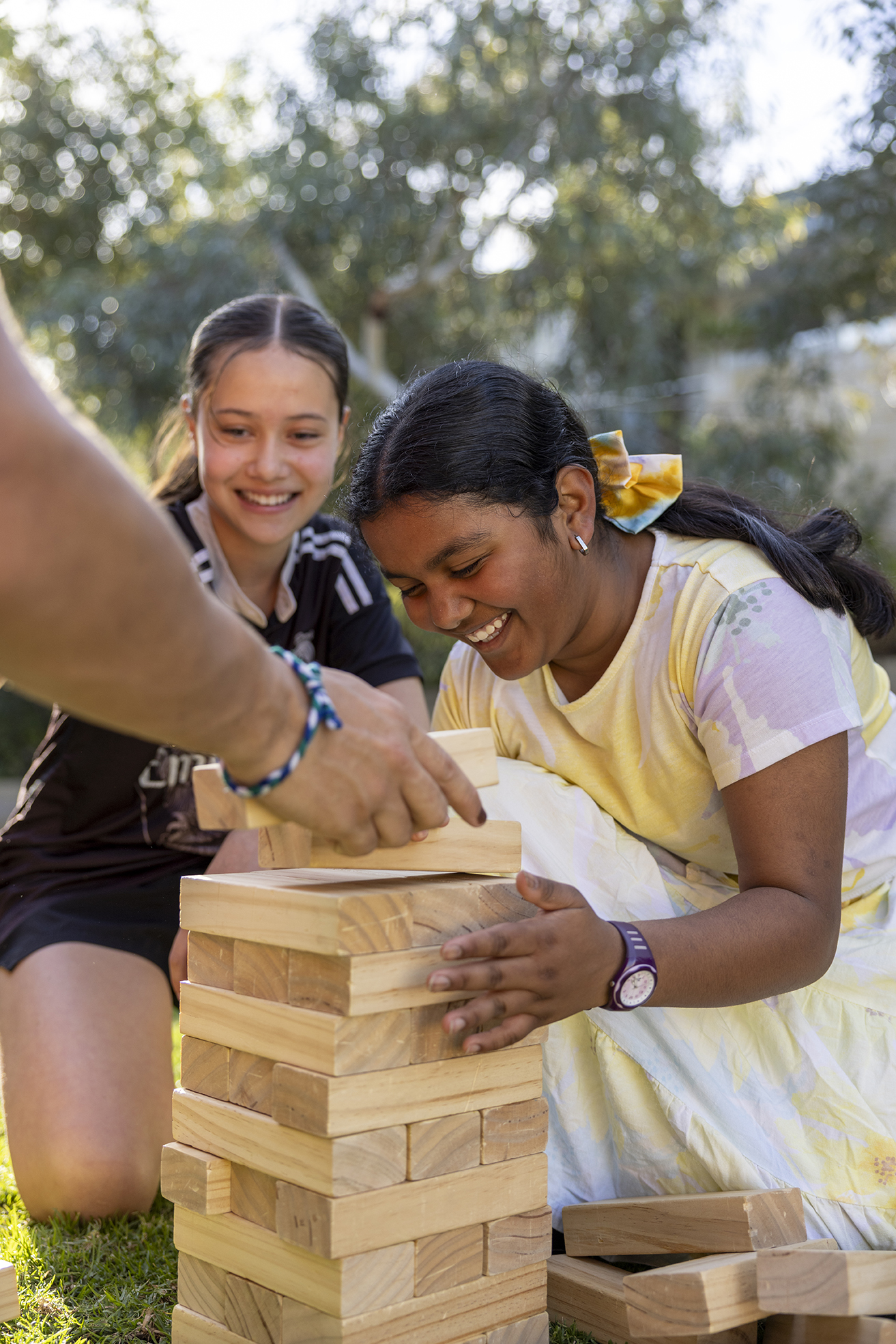 Boarders from City Beach Residential College playing giant jenga on the grass.
