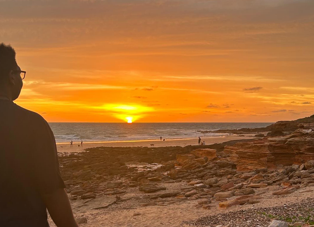 Broome Residential College boarders on the beach against a spectacular sunset