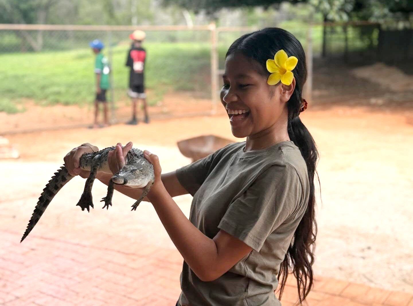 Boarder from Broome Residential College holding a baby crocodile on a trip to the Malcolm Douglas Crocodile Park.