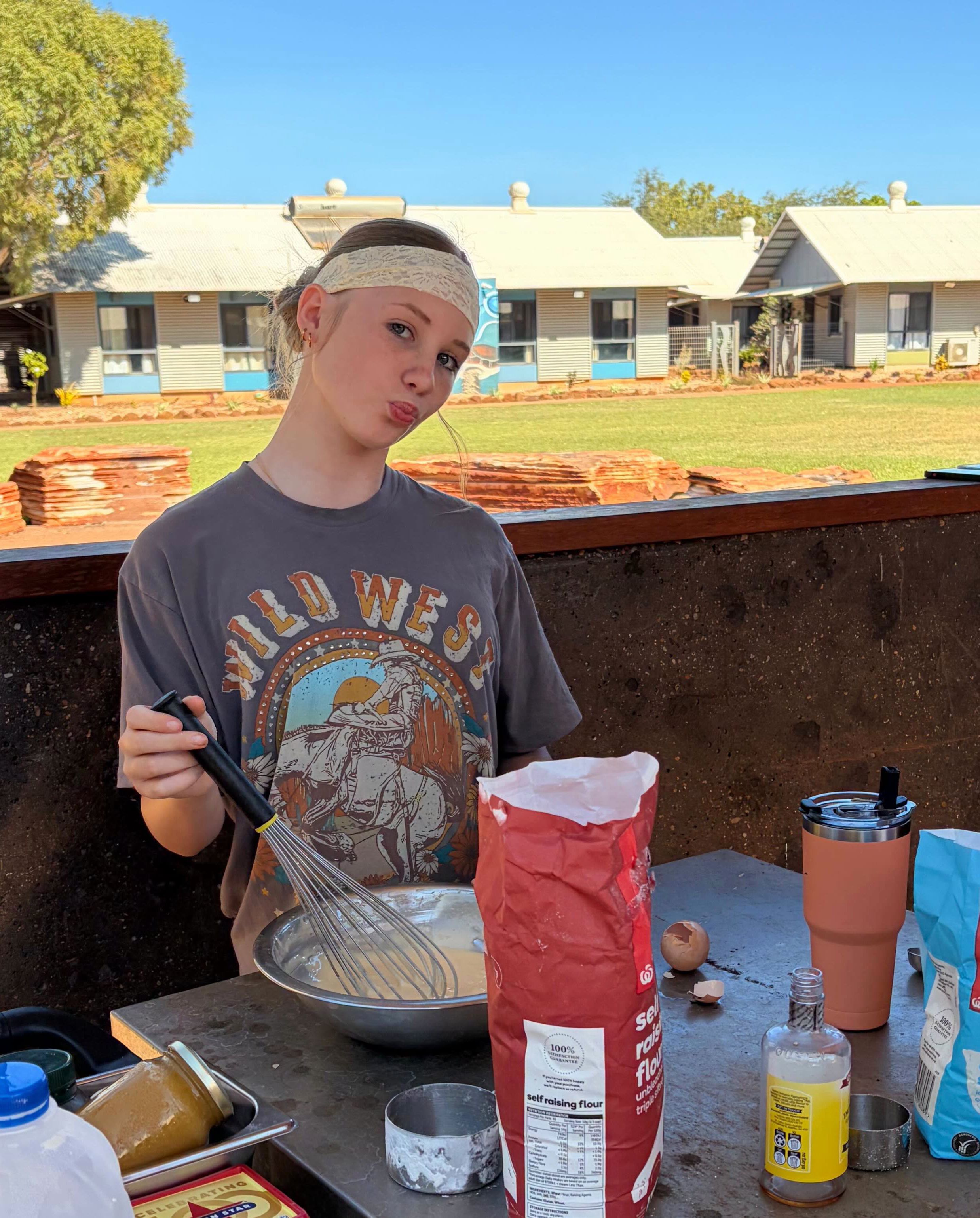 Broome Residential College boarder making pancakes on the BBQ