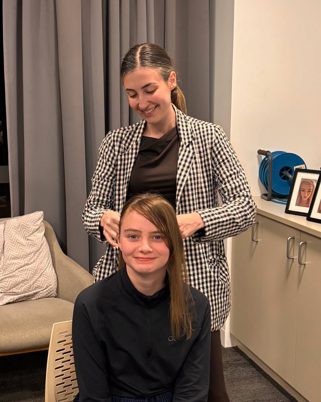 Boarding supervisor from City Beach Residential College braiding student hair before school.