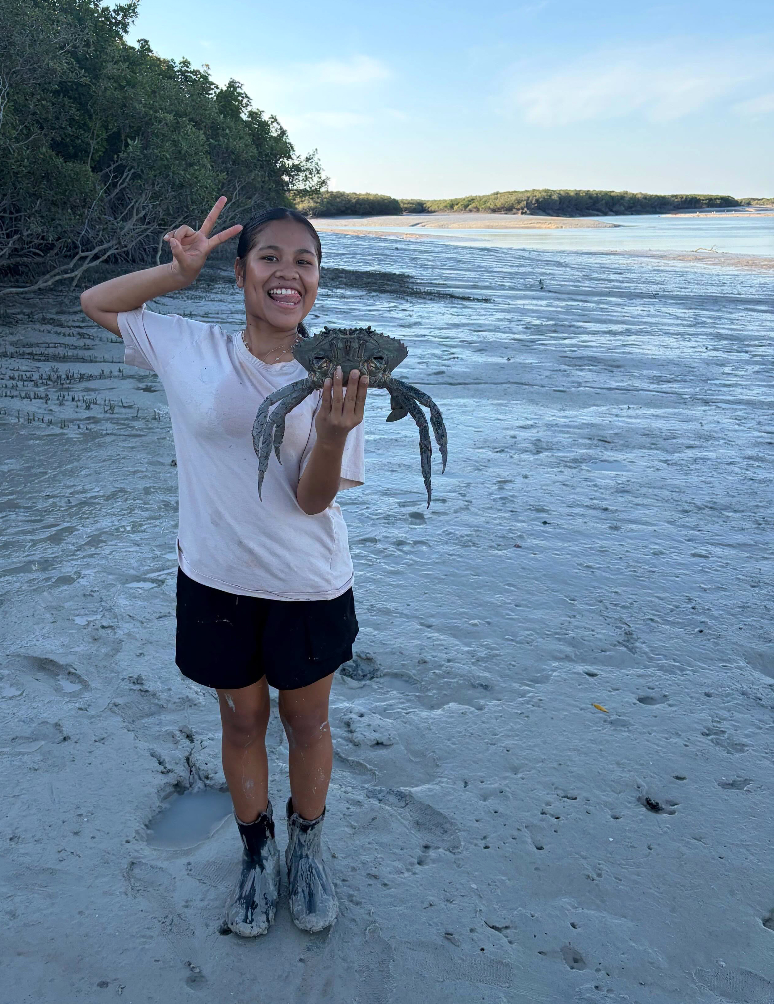 Broome Residential College boarder showing the mud crab she caught on a crabbing excursion. 