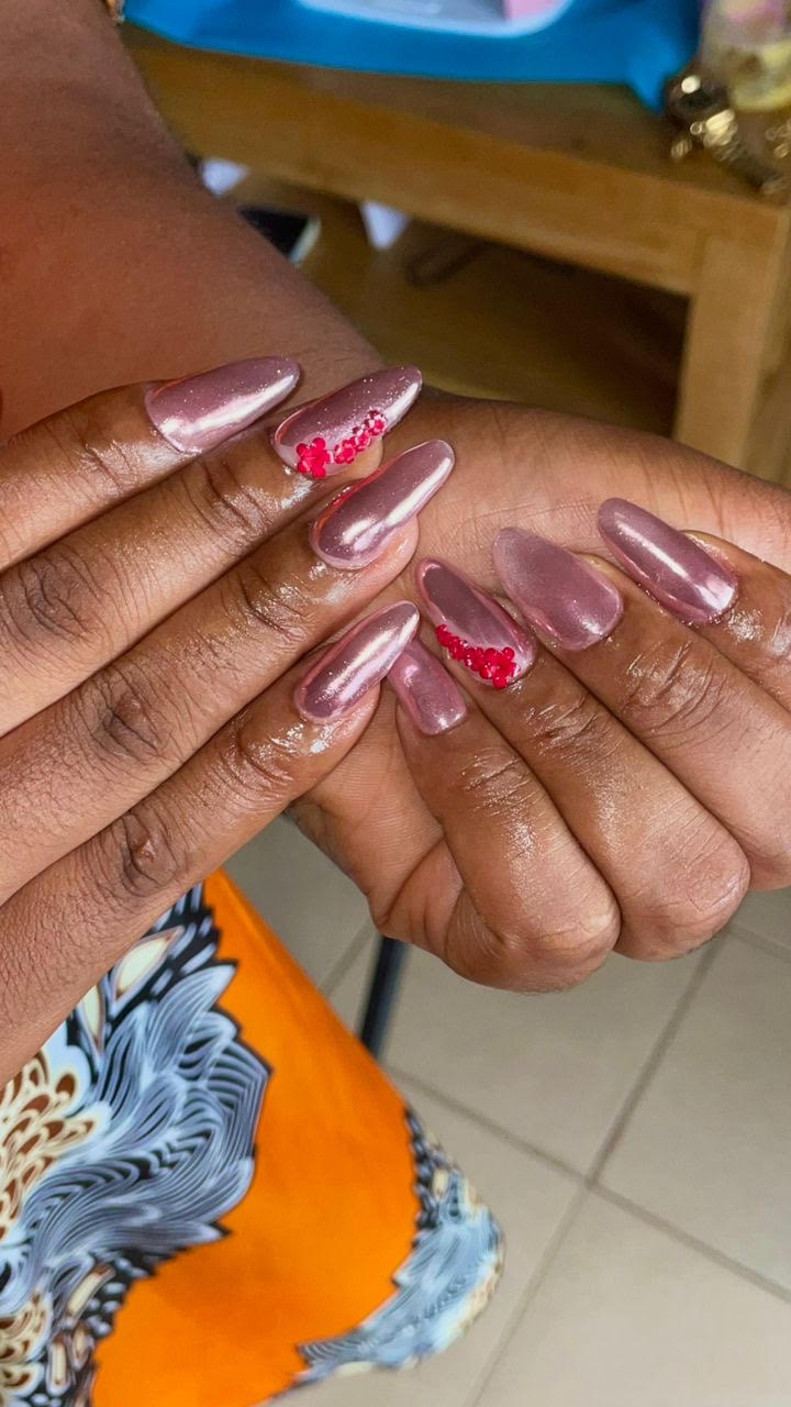 Manucure effet chromé rose avec strass rouges