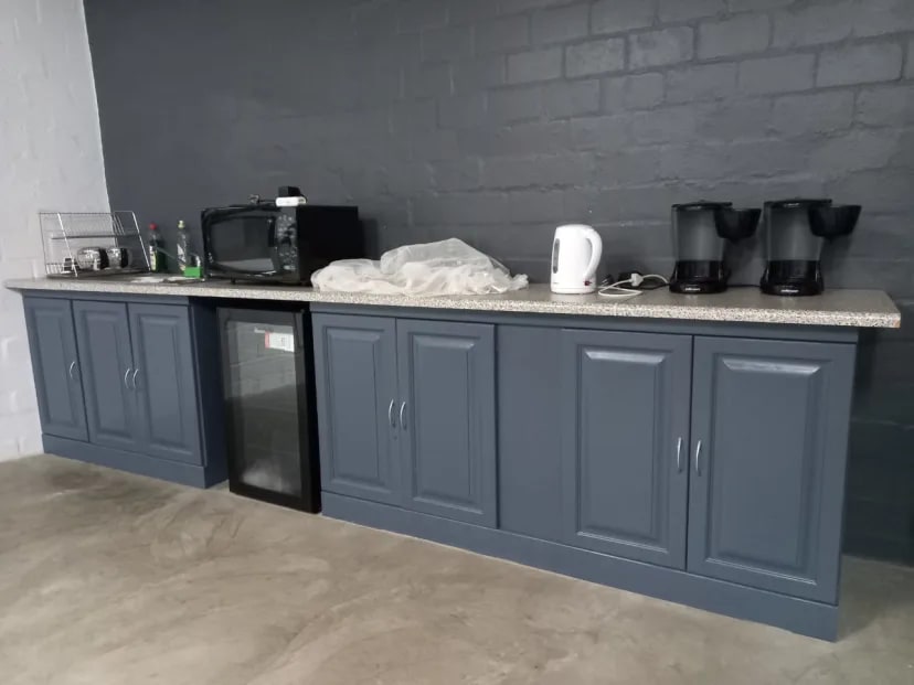 Church kitchen cabinet detail showing smooth gray finish