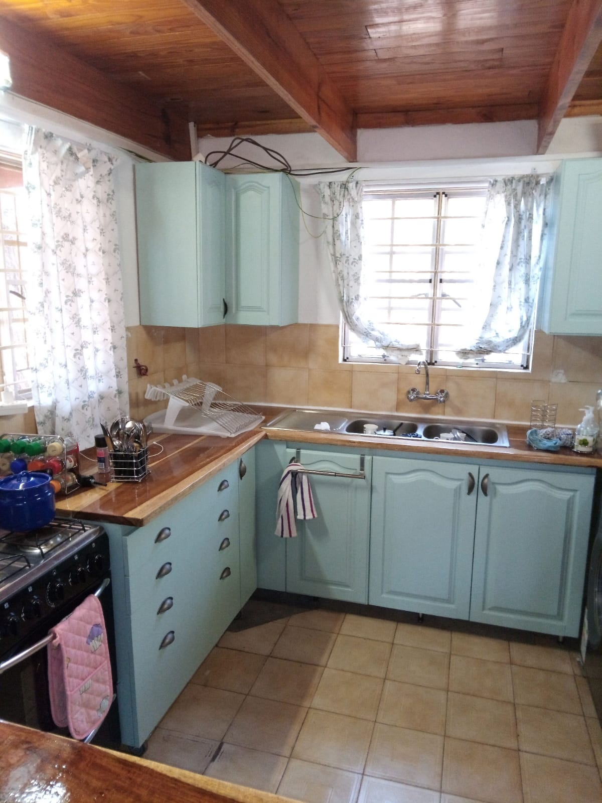 Charming cottage kitchen showing custom open shelving and rustic details