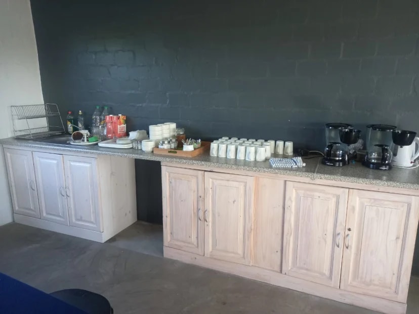 Church kitchen cabinets before refinishing showing natural wood finish