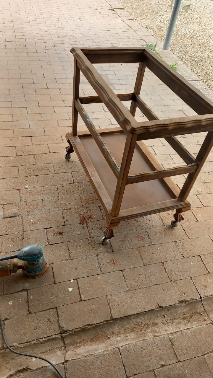 Stripped bar cart frame during outdoor refinishing process