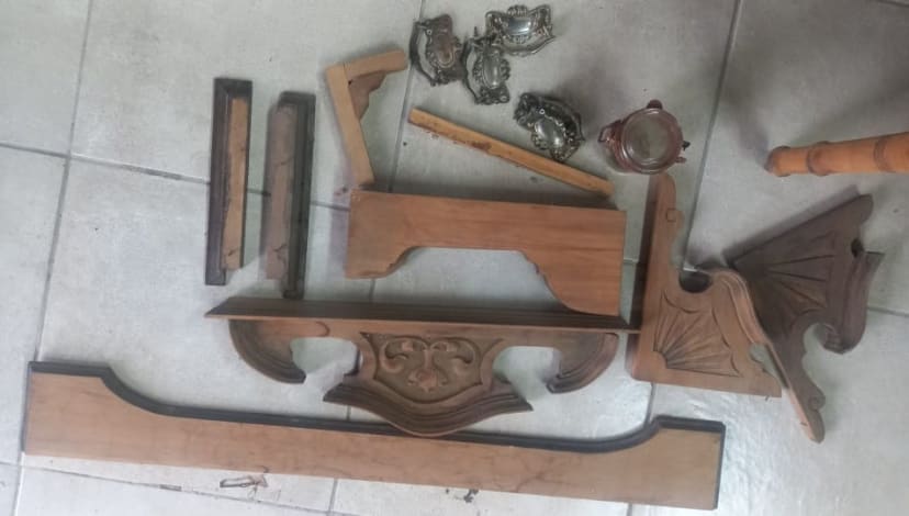 Disassembled ornate mirror frame and carved components