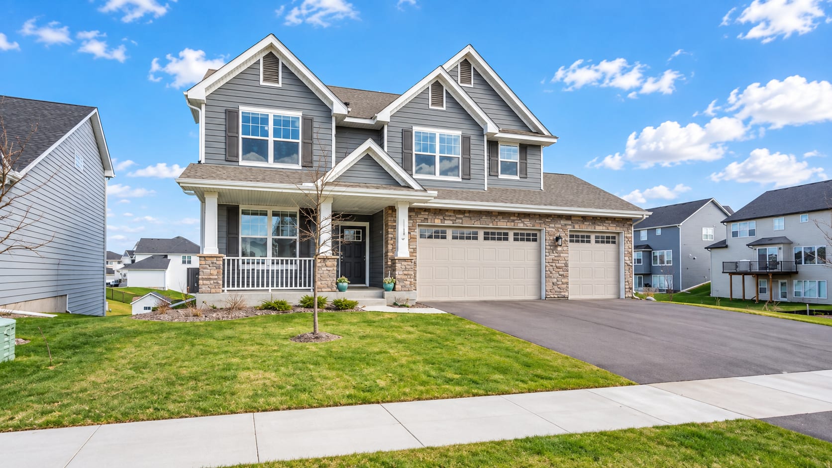 Nearly new Maple Grove home with a front porch and three-car garage
