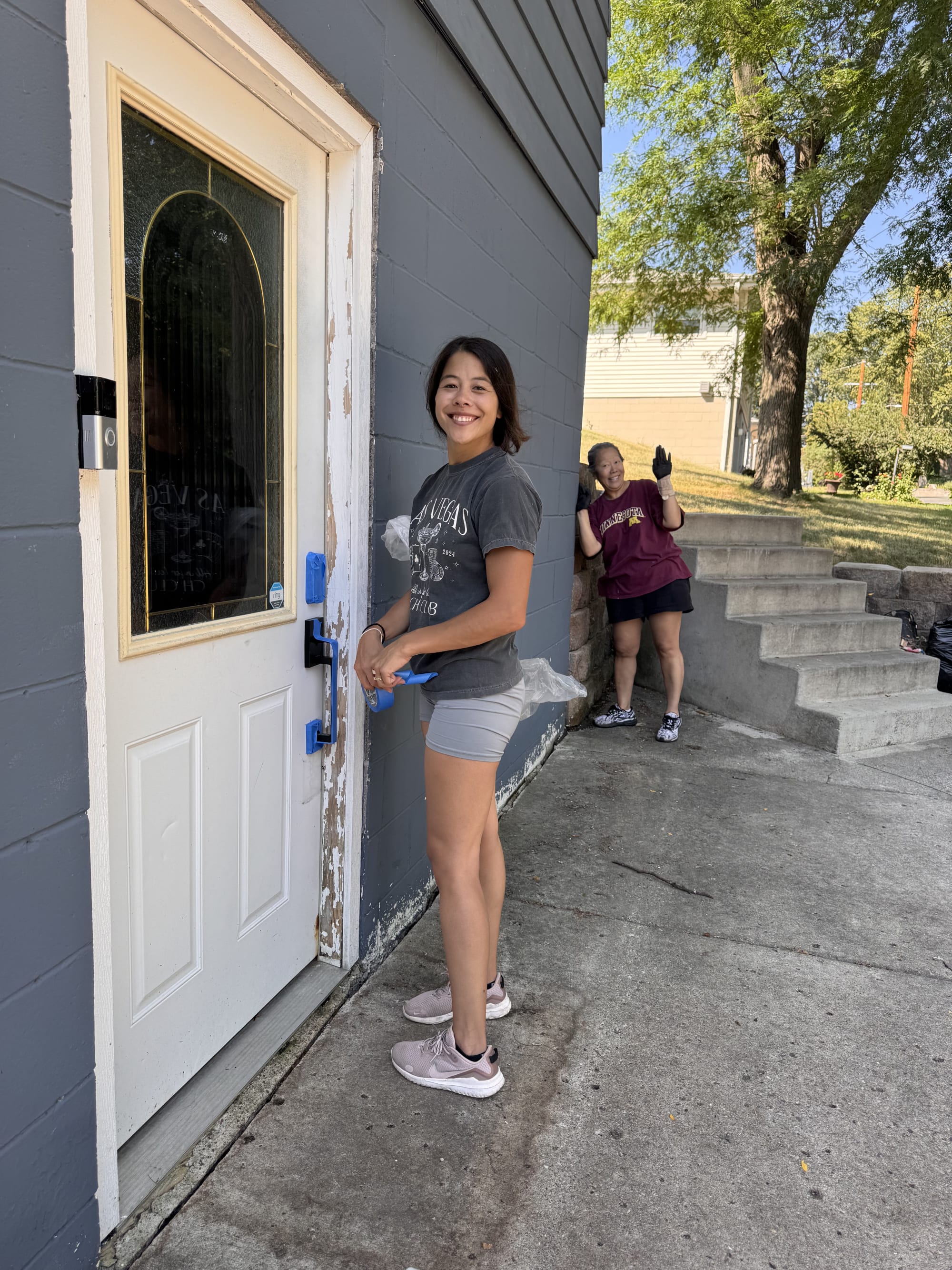 Katy Norman and her mom preparing the exterior of the Black Lake home for painting