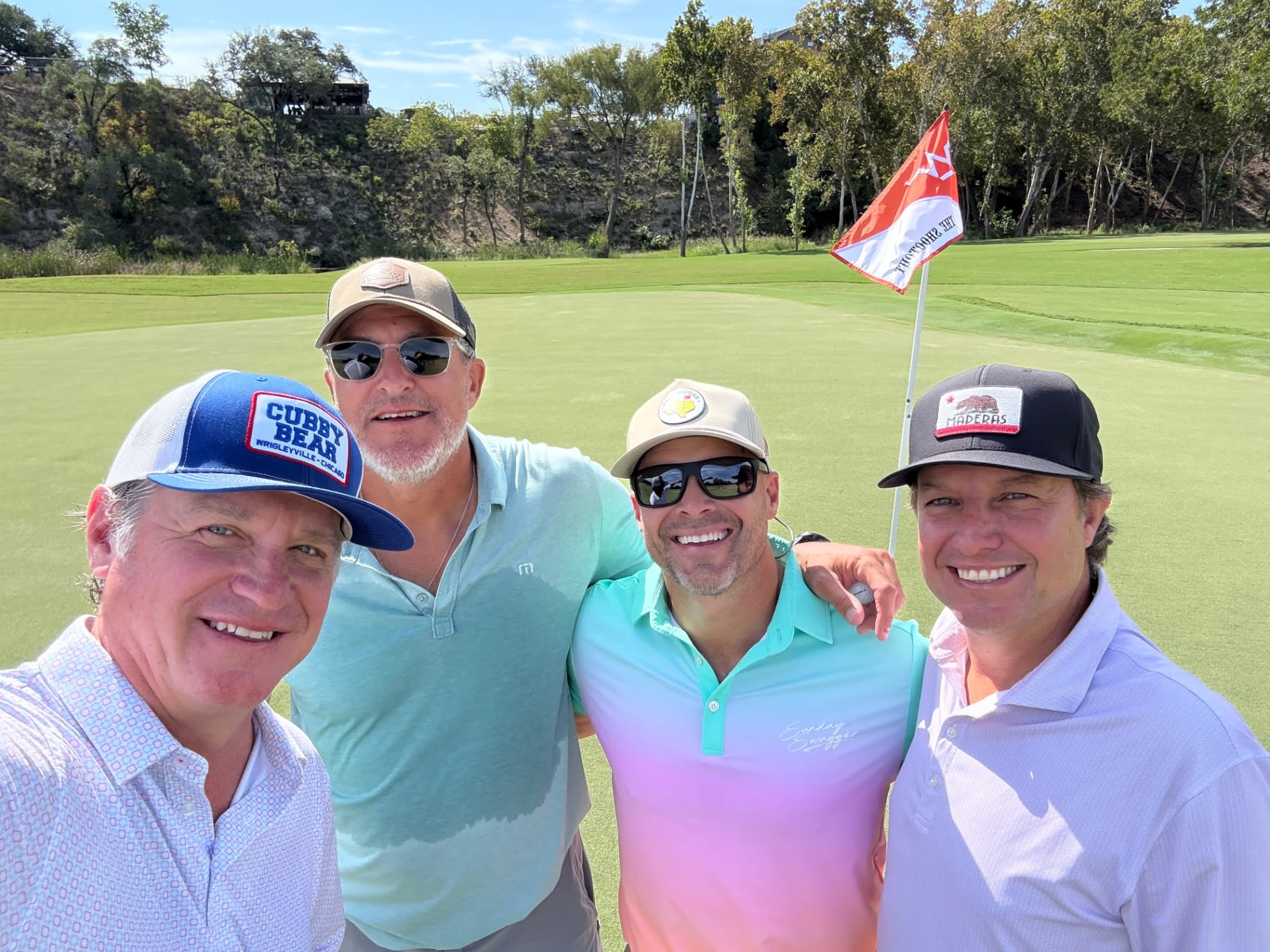 Rick and friends on the green with The Shootout flag at Westlake CC