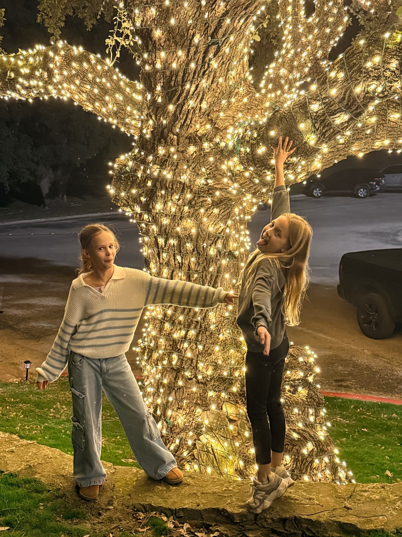 Rick's daughters under the lit oak at Westlake CC during the holidays