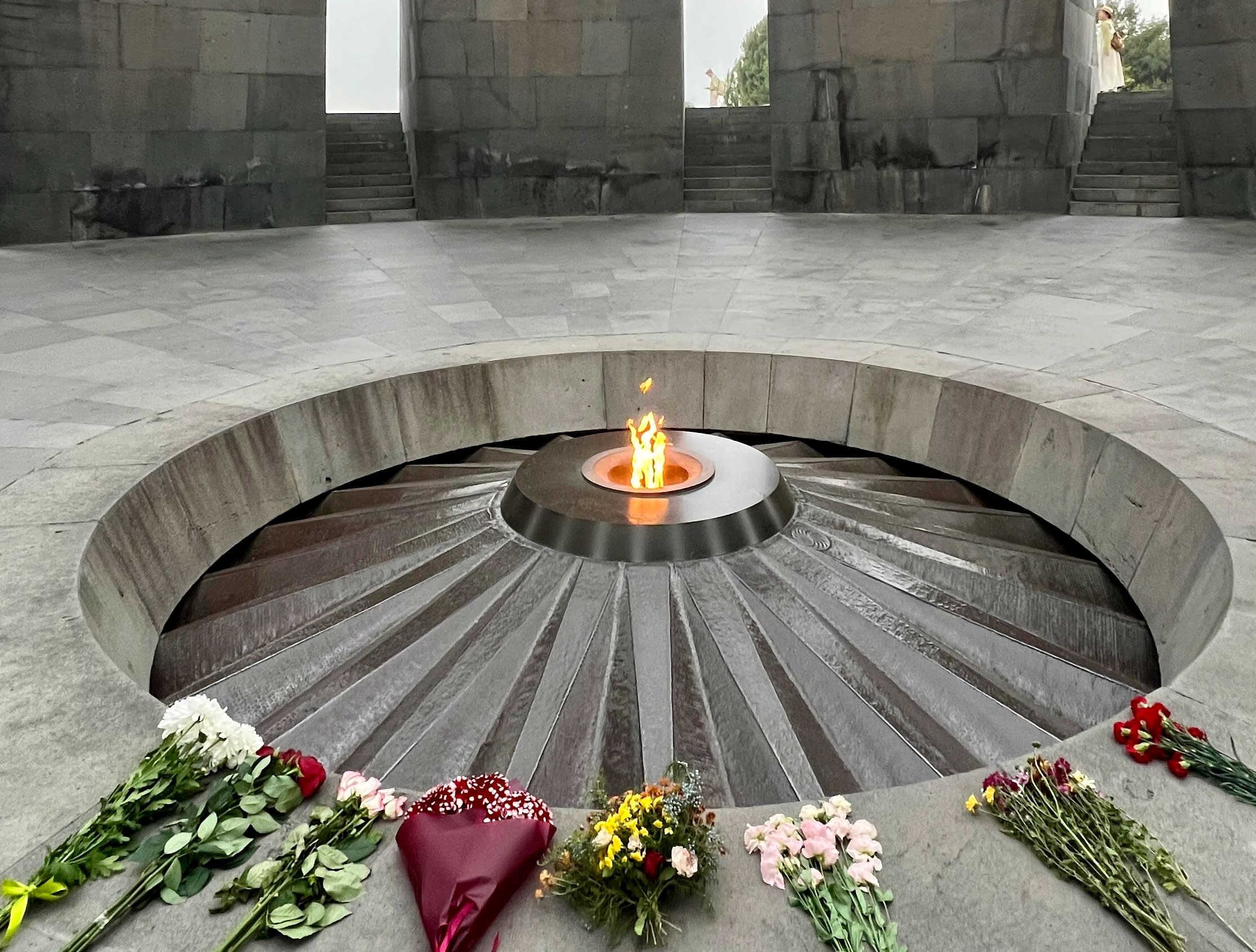 Explore Yerevan's culture where flowers and unique foods bloom beautifully around a fire.
