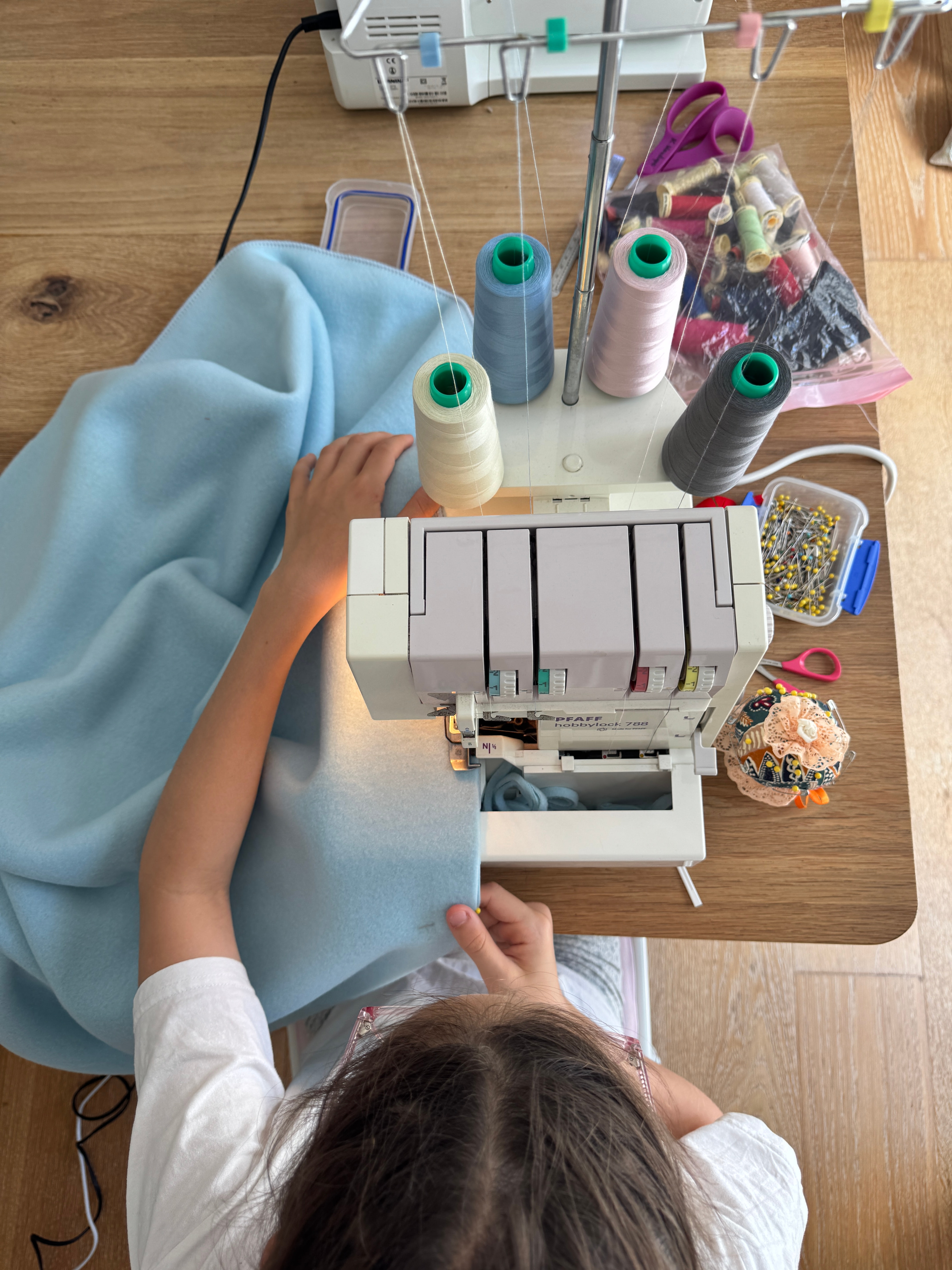 Isla sewing WingSocks at her machine