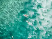 A drone image of two people paddle boating 