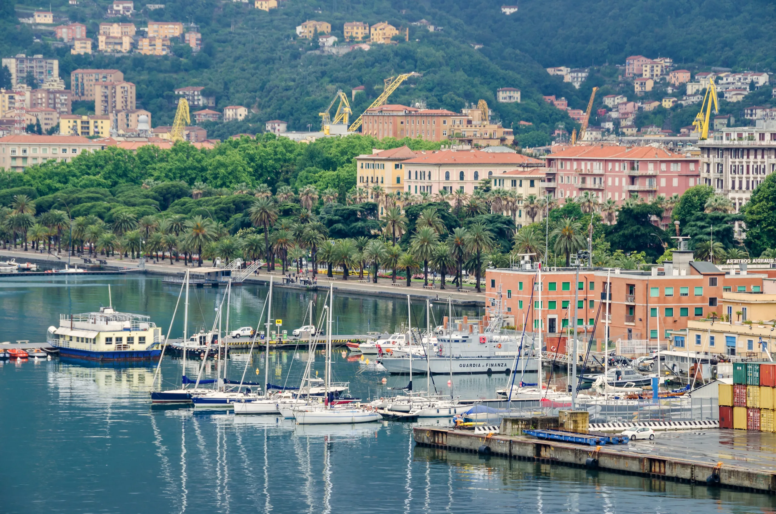 A general view of the city La Spezia, the chief Italian naval station and arsenal, from the sea, showing containers of the city s port, marina and palm-lined water front Morin by rainy weather