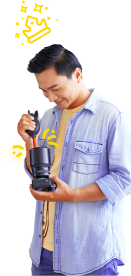 Man cleaning a lens