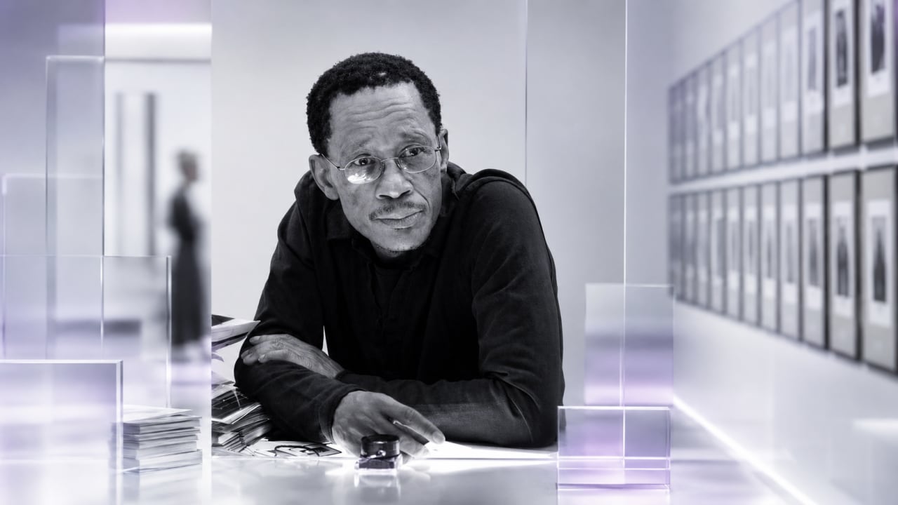 Editorial visual representing Santu Mofokeng’s Rumours/2026 exhibition at the Standard Bank Art Lab, with black-and-white gallery frames, archival notes, domestic memory textures, subtle Bloemhof landscape cues and premium Viranova purple-and-gold glass styling.
