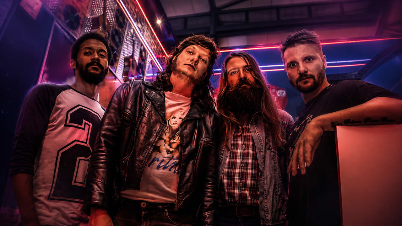 Editorial visual representing Ruff Majik’s Gods of War as a limited physical EP, featuring a CD case, handwritten tracklist notes, worn gig posters, smoky rehearsal-room shadows, fans passing a disc between hands and premium Viranova purple-and-gold underground-rock styling.