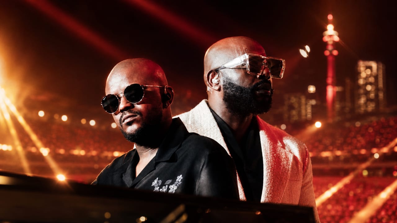 Editorial visual representing Scorpion Kings Live at FNB Stadium as a stadium-scale Amapiano moment, with glowing crowd lights, ticketing queue elements, log-drum waveforms, purple-and-gold Viranova glass styling and Johannesburg live-music energy.