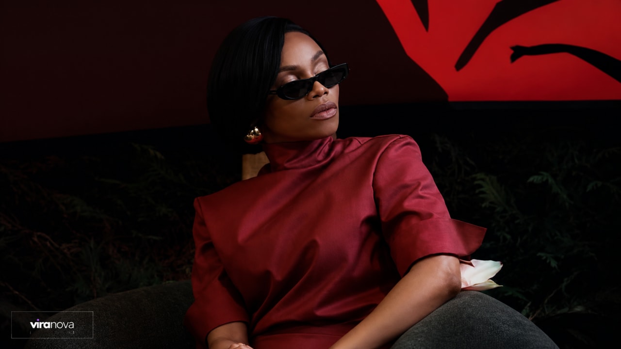 Editorial visual representing Bonang Matheba at Cannes Lions discussing AI, culture and trust, featuring a luxury panel setting, terracotta African fashion cues, abstract algorithm grids, cultural pattern fragments and premium Viranova purple-and-gold glass styling.