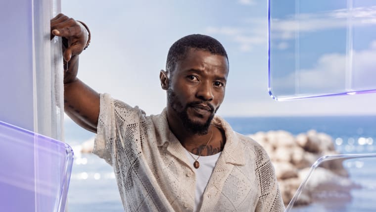 Editorial visual representing Abdul Khoza’s return to acting through Uzalo, featuring a dramatic KwaMashu television set, biker-gang atmosphere, polished kingpin styling, township street textures, emotional actor comeback energy, deep purple shadows, gold highlights and premium Viranova glass styling.
