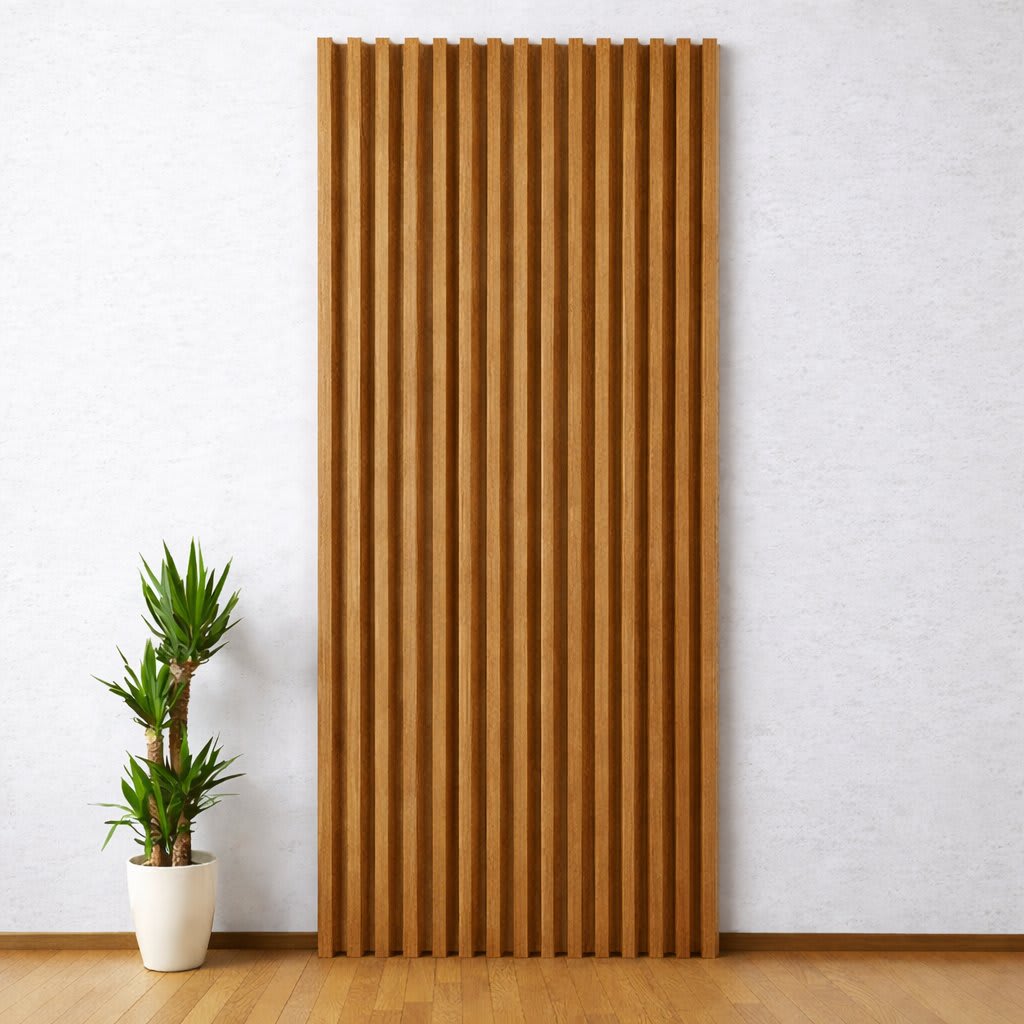 A tall, vertical WPC wall panel with pine textured slats stands out against a light-colored wall in a minimalist, modern interior, paired with a small potted plant on a warm wooden floor, creating a serene and clean design.