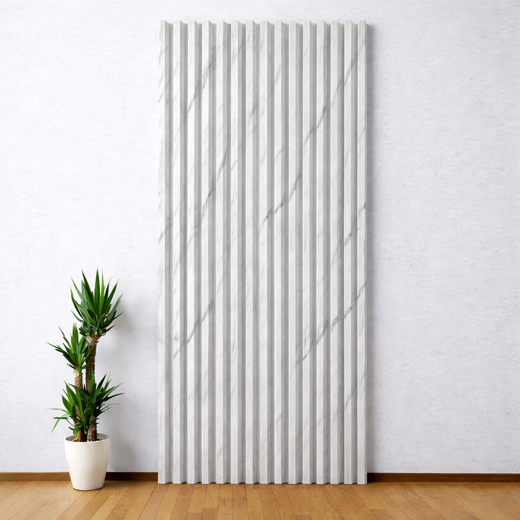 A tall, vertical WPC wall panel with simulated marble textured slats stands out against a light-colored wall in a minimalist, modern interior, paired with a small potted plant on a warm wooden floor, creating a serene and clean design.
