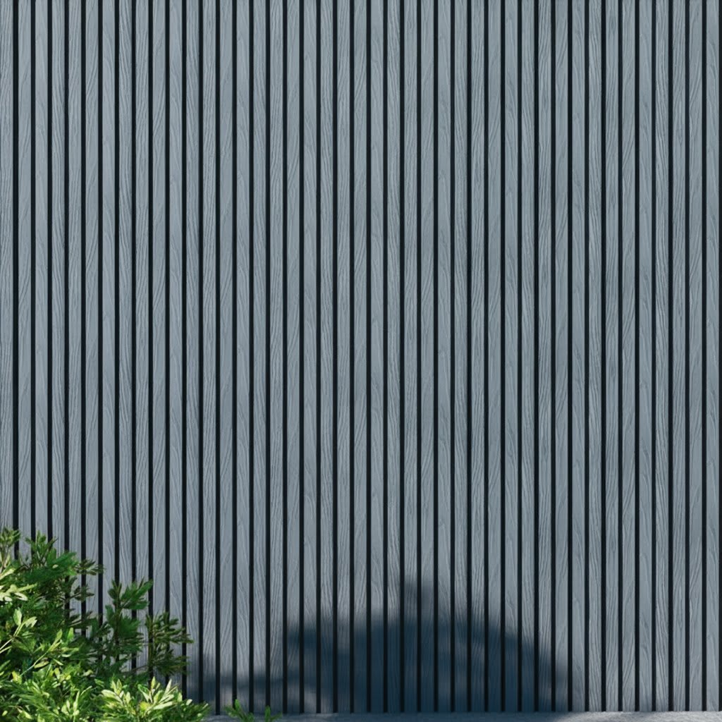 WPC slatted wall panels in gray tones, featuring uniform vertical slats and a natural wood grain texture, framed by green foliage and soft shadows. A minimalist architectural facade ideal for backgrounds, exteriors, design, and nature-inspired concepts.
