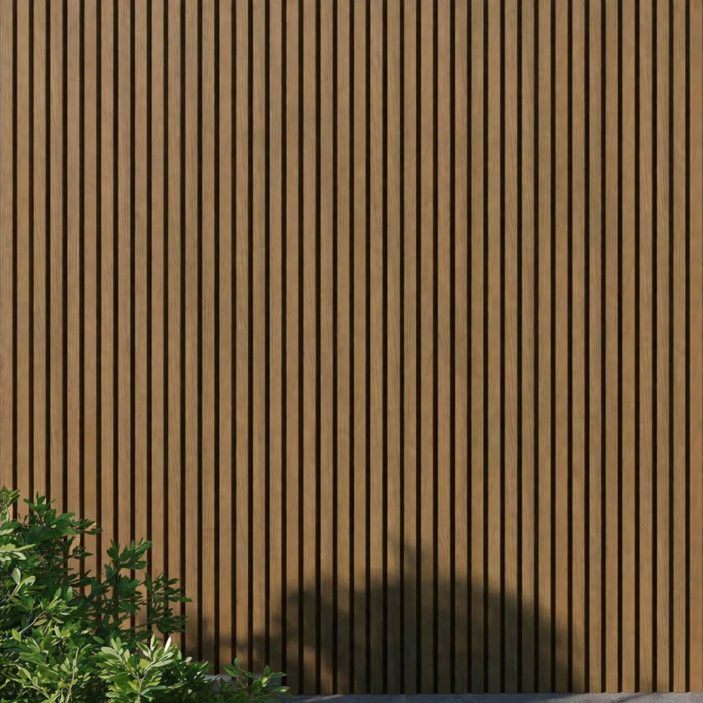 WPC slatted wall panels in oak tones, featuring uniform vertical slats and a natural wood grain texture, framed by green foliage and soft shadows. A minimalist architectural facade ideal for backgrounds, exteriors, design, and nature-inspired concepts.