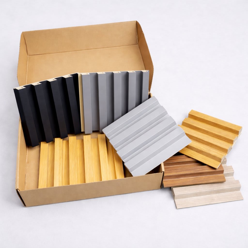 Organized display of wpc wall panels color samples in a cardboard box, showing varied finishes, textures and tones for interior design, renovation projects, material selection and product presentation.