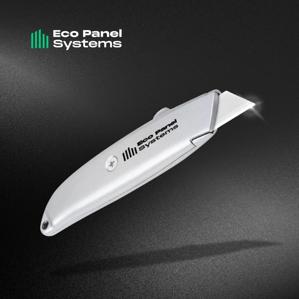 Sleek silver utility knife with a sharp retractable blade and Eco Panel Systems logo, isolated on a textured dark background — modern cutting tool for packaging, crafts, DIY and industrial tasks.