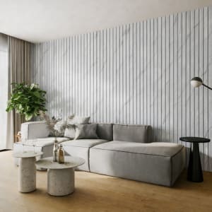 A minimalist interior featuring a tall vertical WPC radiator panel against a light-colored wall, alongside a green potted plant on a warm hardwood floor, evoking modern Scandinavian design and a sense of tranquility.